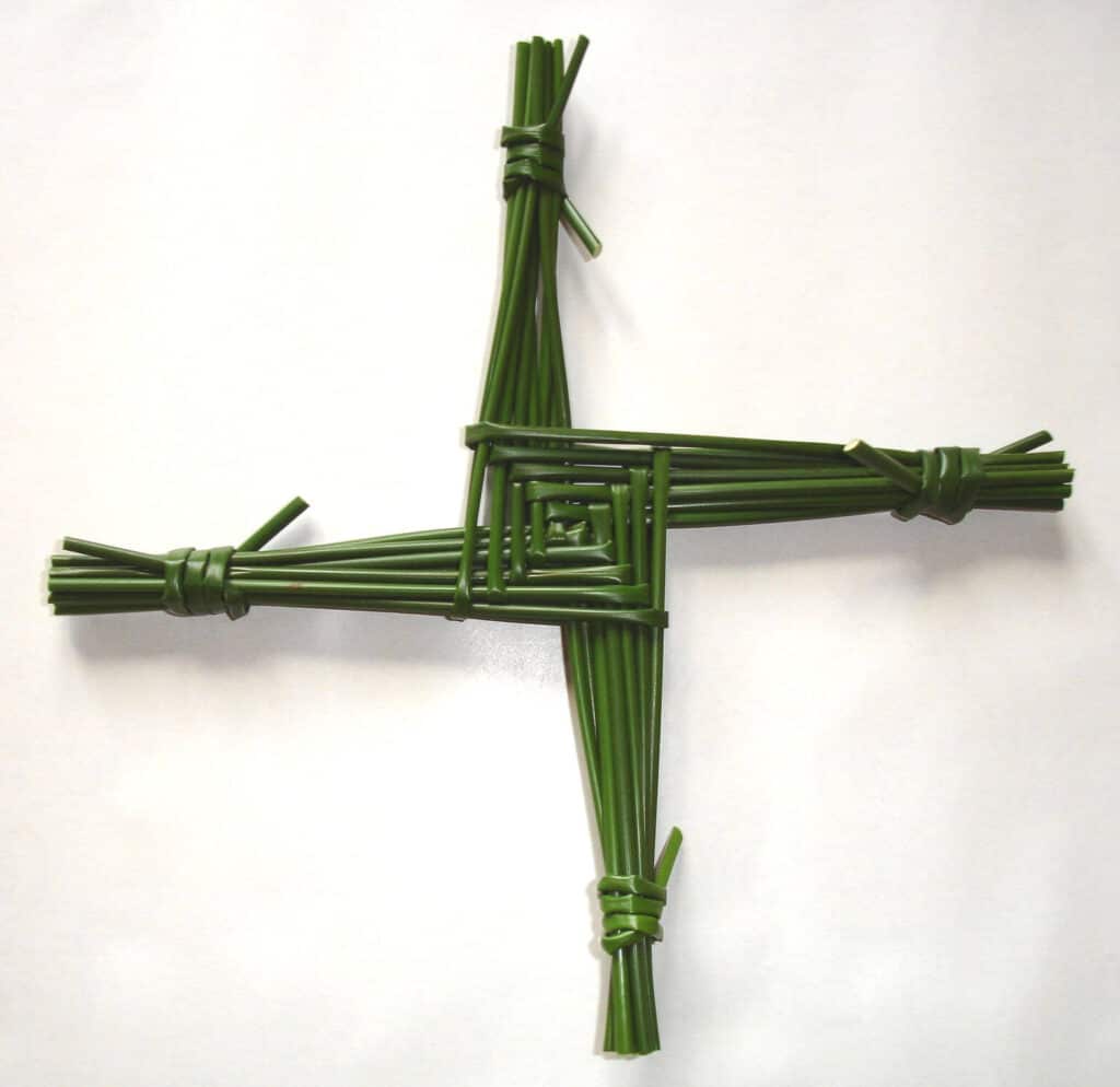 Saint Brigid's Cross green woven four arms tied at the ends and a woven square in the middle. 