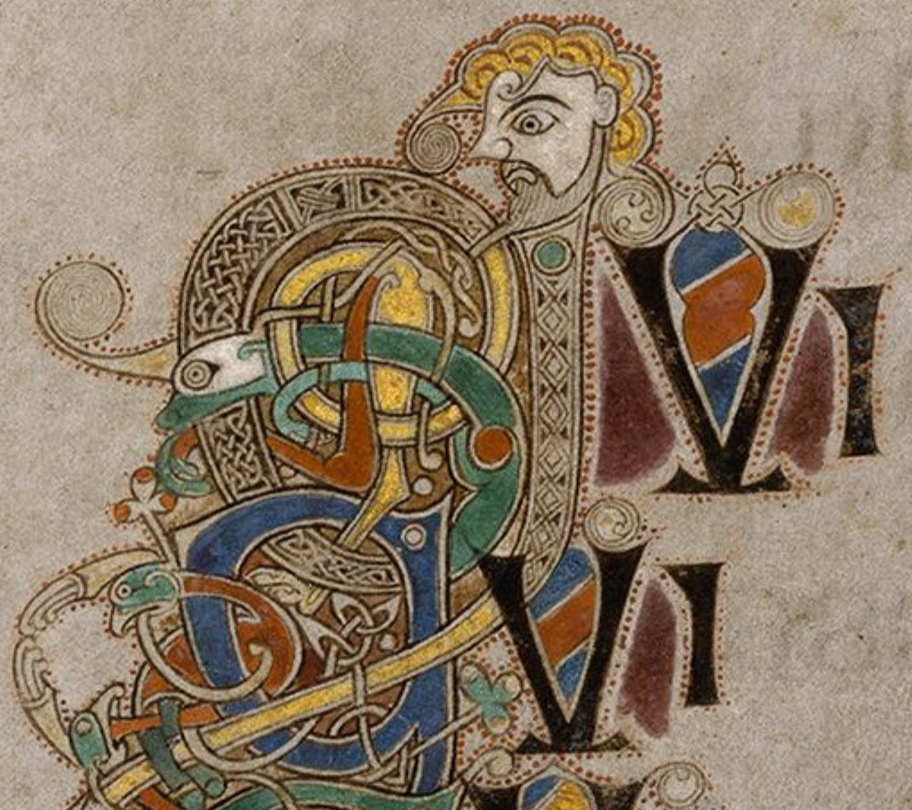 Detail from the Book of Kells: a bearded man with curly yellow hair whose body twists into a knotted initial in blue, green, yellow and red