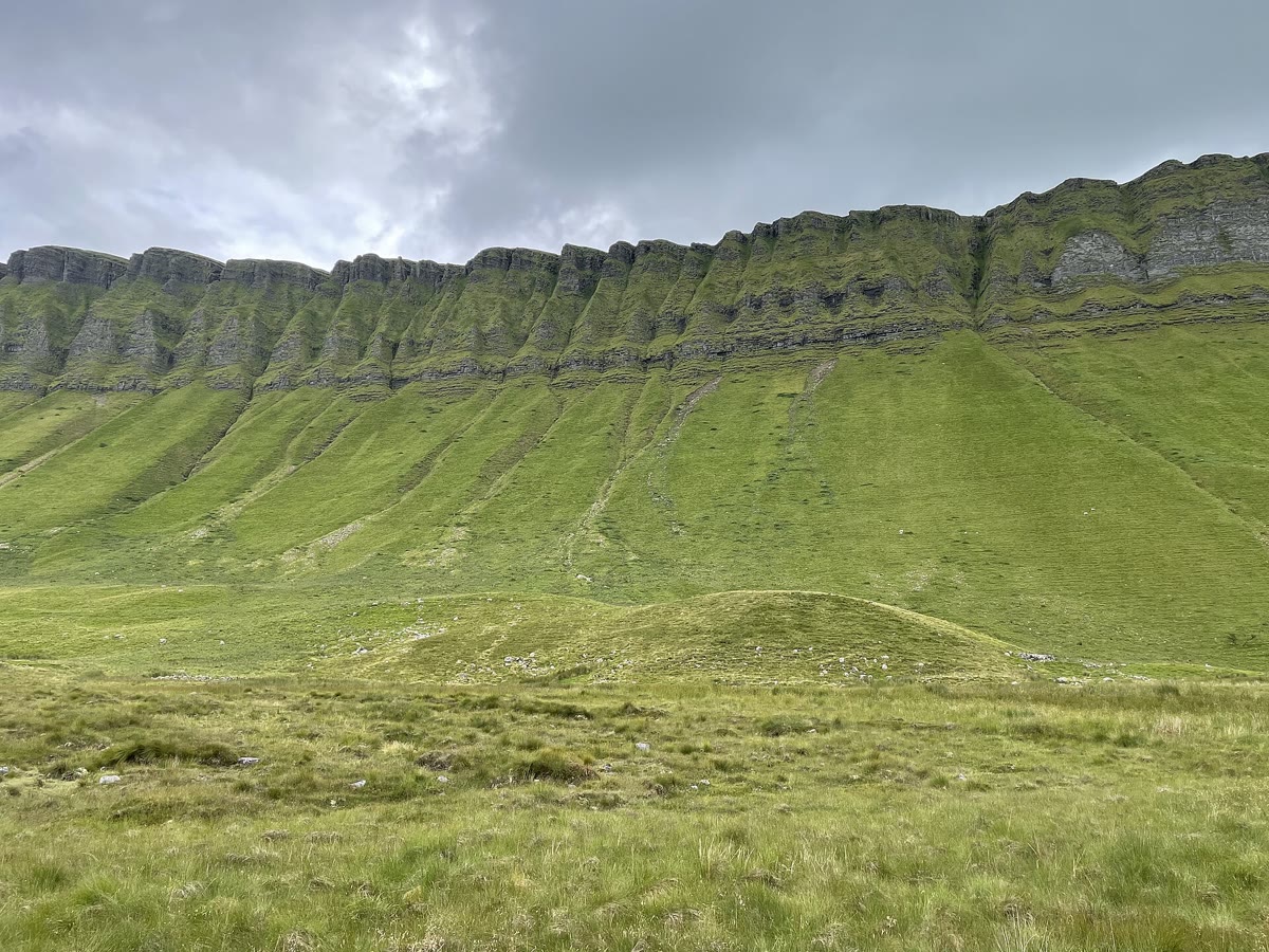 The steep green ribbed slopes and limestone cliffs of Ben Bulben in Co. Sligo, where Diarmuid's last boar hunt is set