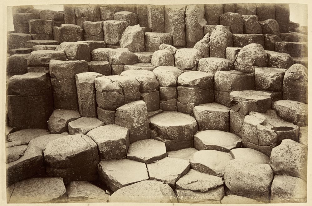 Sepia photograph from about 1888 of the Wishing Chair: low six-sided columns forming a natural seat, with a back of taller columns rising behind it