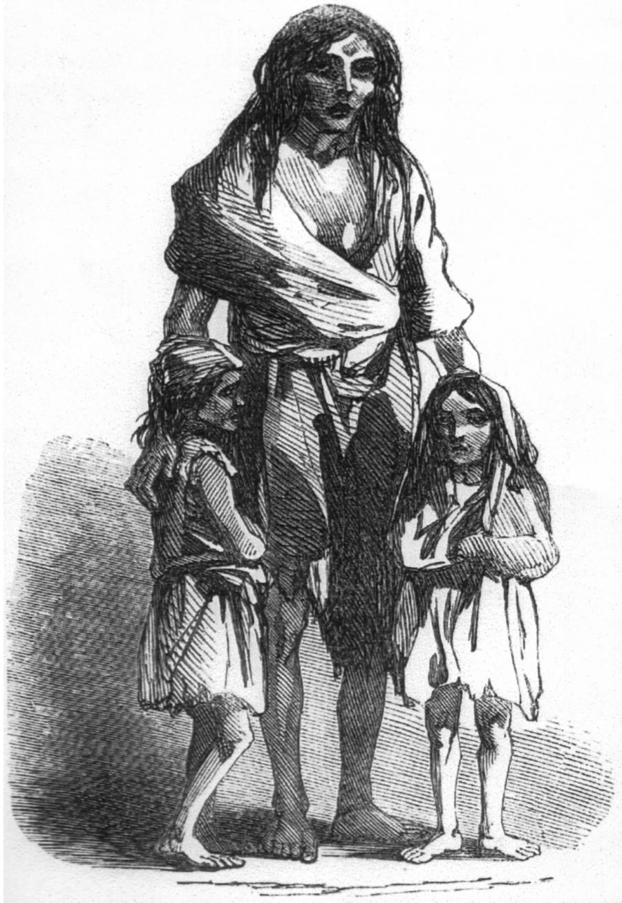 1849 engraving of a gaunt, barefoot Irish mother in ragged clothes standing with two thin children during the Irish potato famine