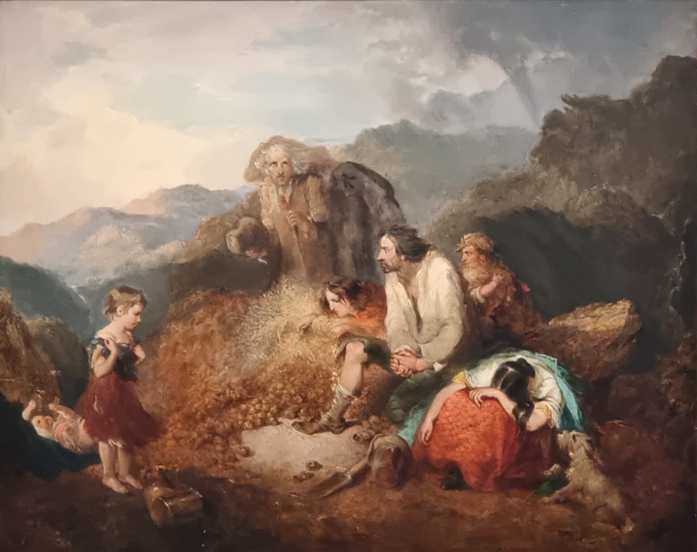 1847 oil painting of an Irish country family in a mountain landscape, grieving over a heap of rotten potatoes they have just dug up