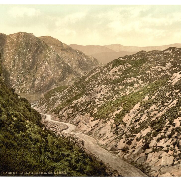 Hand-coloured 1890s photochrom of a narrow road winding up through the rocky Pass of Ballaghbeama in Co. Kerry