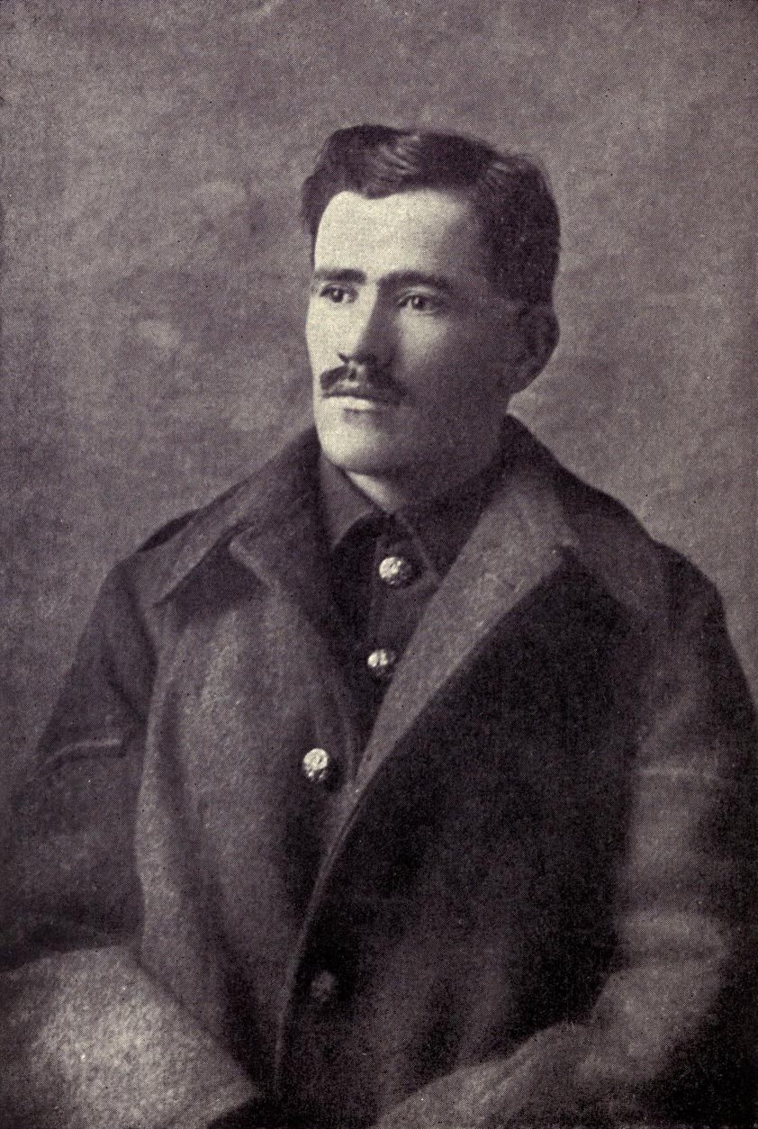 Old photograph of the poet Francis Ledwidge in a soldier's greatcoat with brass buttons, with dark hair and a moustache, looking to one side