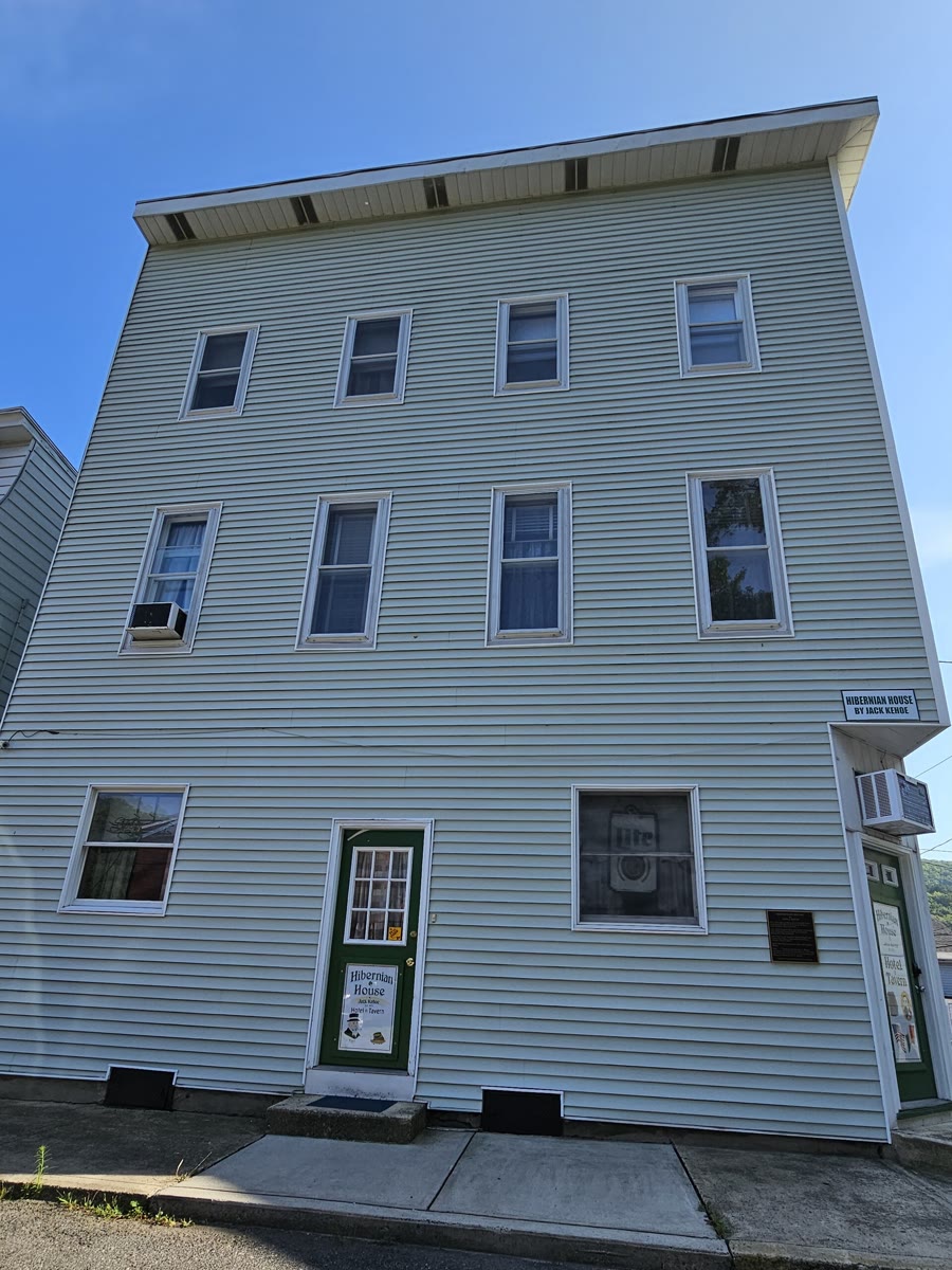 Three-storey pale green clapboard-style building with green doors and a small sign reading Hibernian House by Jack Kehoe, Girardville, Pennsylvania