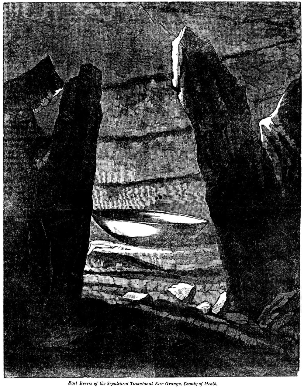 1833 engraving of the east recess inside Newgrange: tall upright stones around a shallow stone basin in the dark chamber